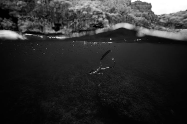 Half Underwater Photo Of Woman Diving 