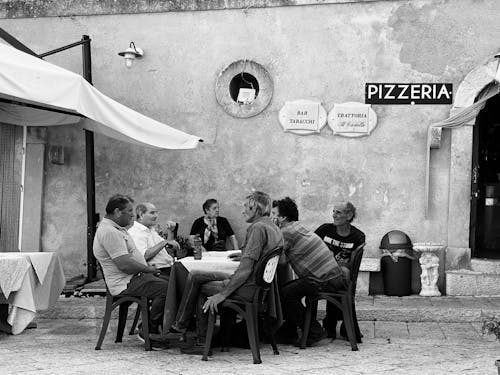 Men Sitting on Chair while having Conversation