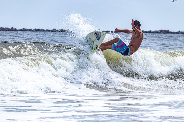 Man Surfing On A Wave