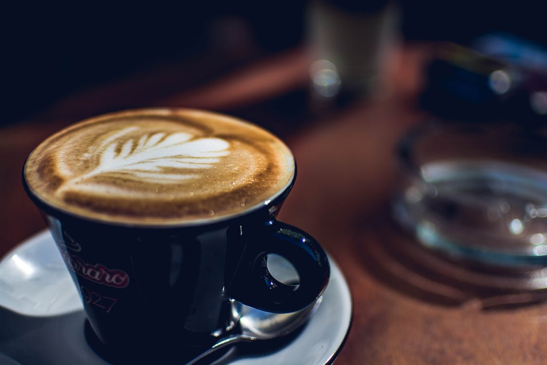 Free Blue Coffee Mug Near on Glass Ashtray Stock Photo