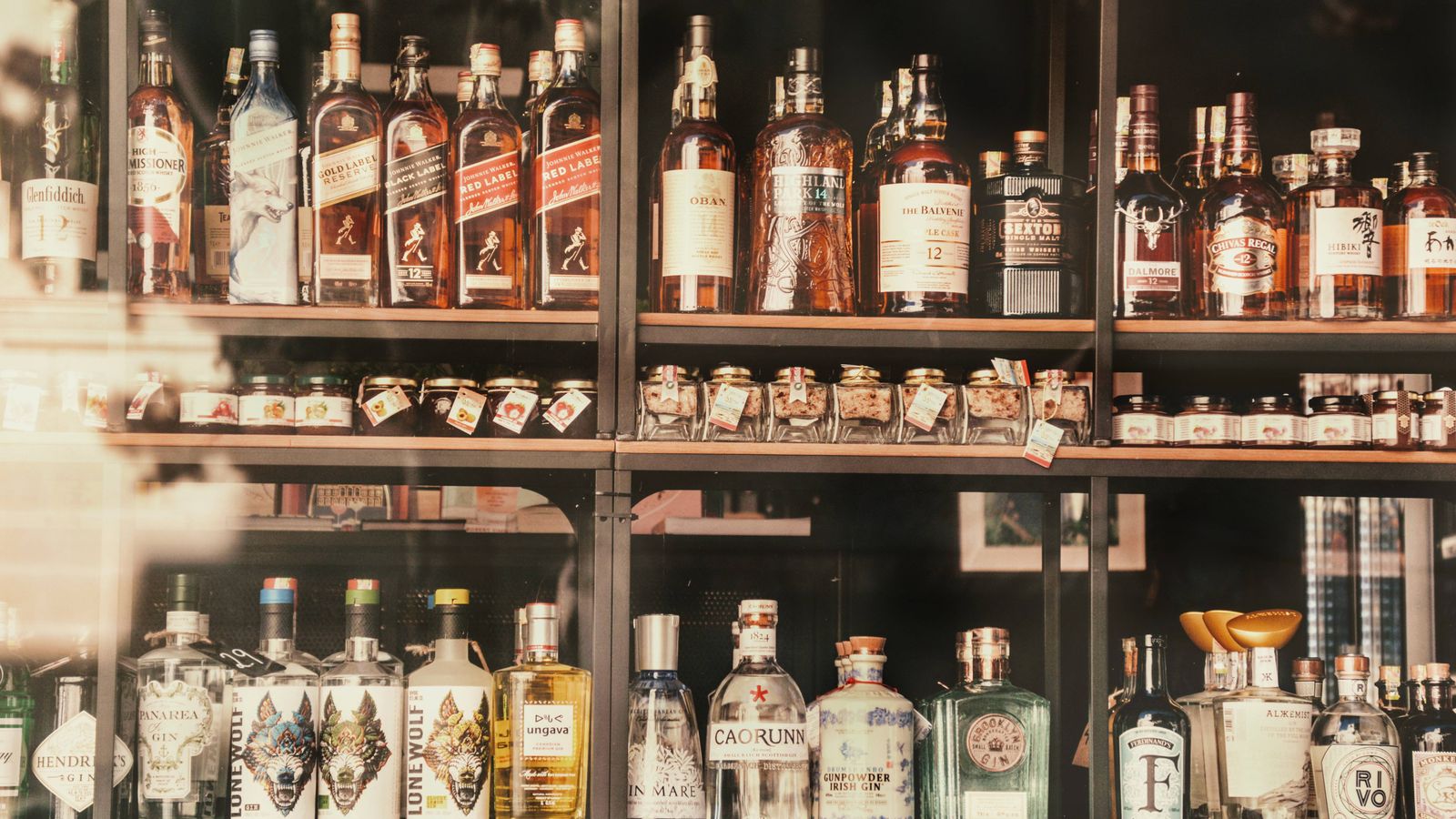 A diverse selection of liquor bottles elegantly displayed on shelves in Valletta, Malta.