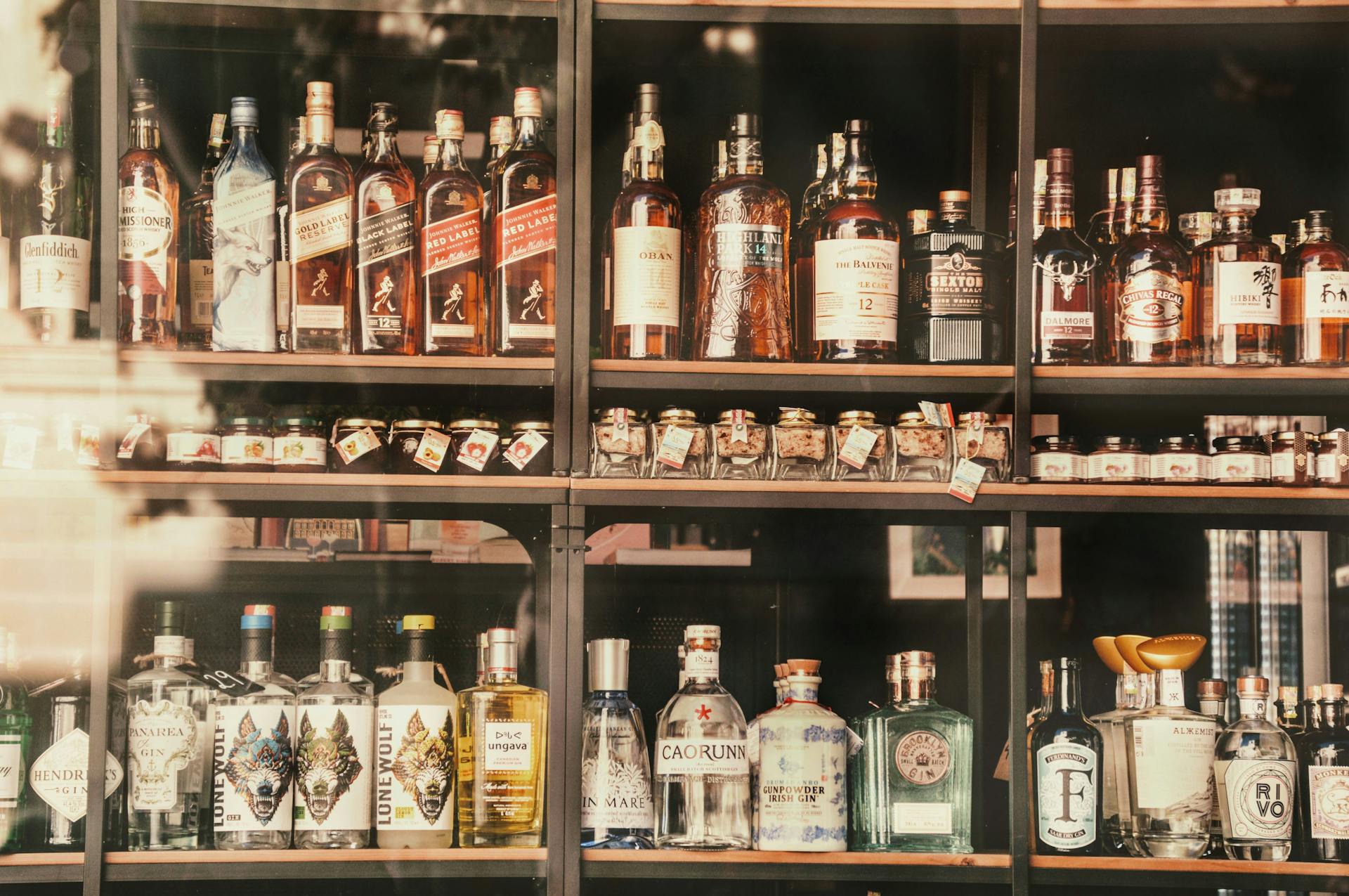 A diverse selection of liquor bottles elegantly displayed on shelves in Valletta, Malta.