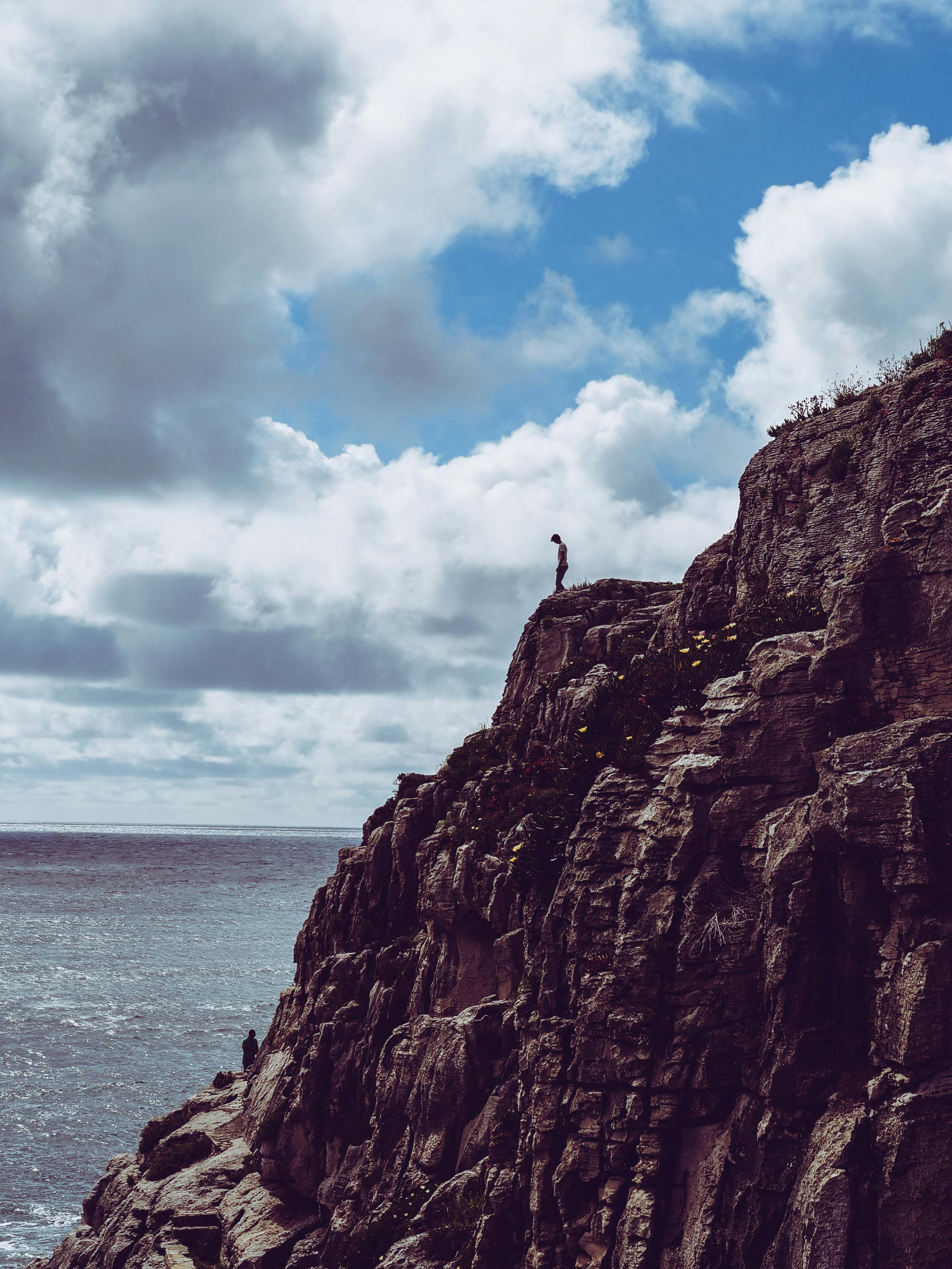 Person Standing On Cliff · Free Stock Photo