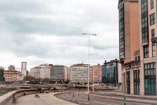 Free Modern cityscape of La Coruña, Spain with high-rise buildings and people walking on the street. Stock Photo