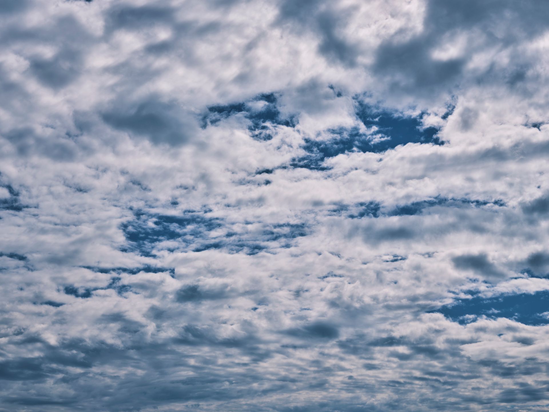 A striking cloudscape with scattered clouds and blue sky, perfect for weather or nature-themed projects.