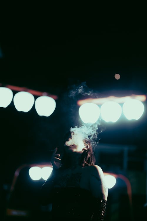A Tattooed Woman Smoking a Cigarette