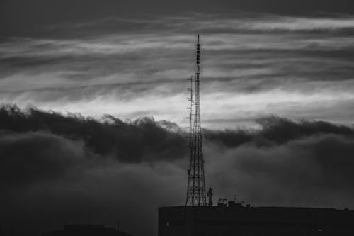 Antenna on Building Roof Against Storm Cloud