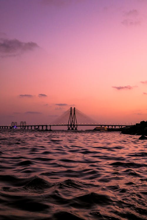 A Bridge over the Sea Under Pink Sky