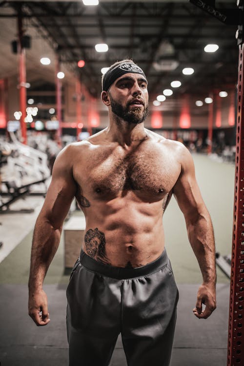 Topless Man Standing in the Gym while Looking Afar