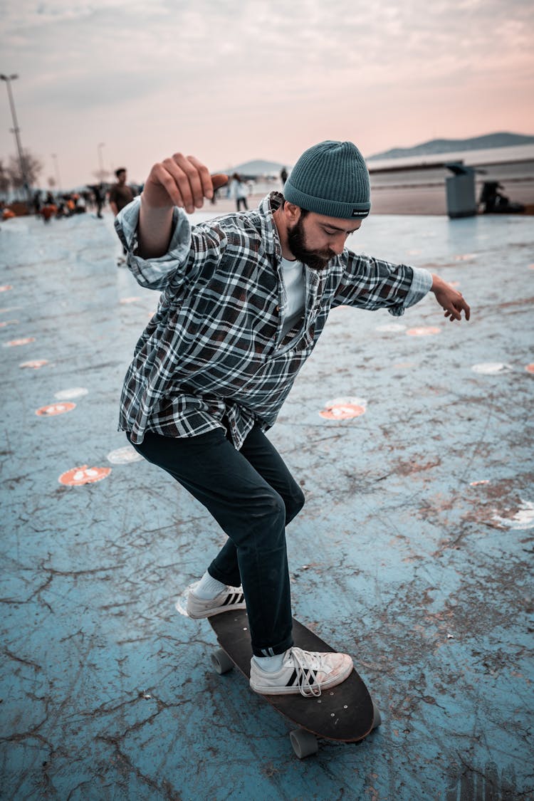 A Man Using Longboard