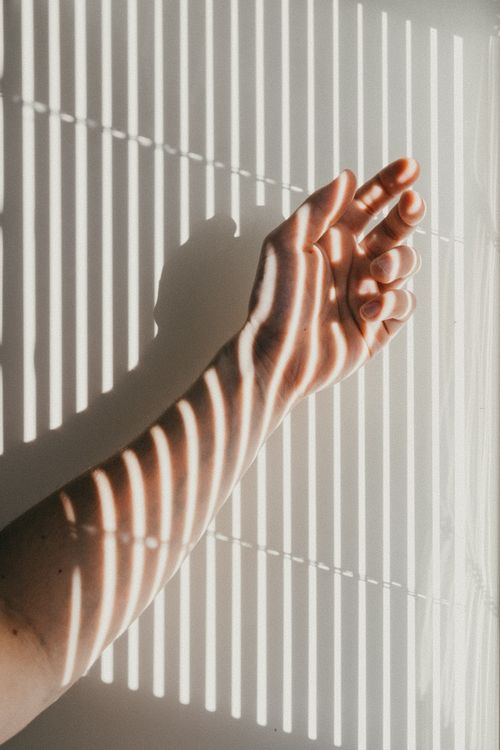 Shadow From Blind on Persons Arm · Free Stock Photo