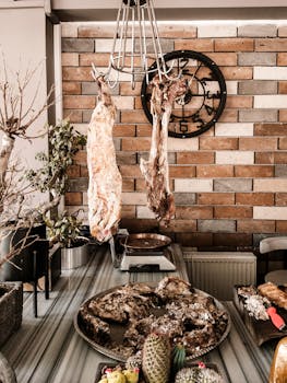 Hanging meats and food display on a rustic brick wall background with a modern kitchen vibe.