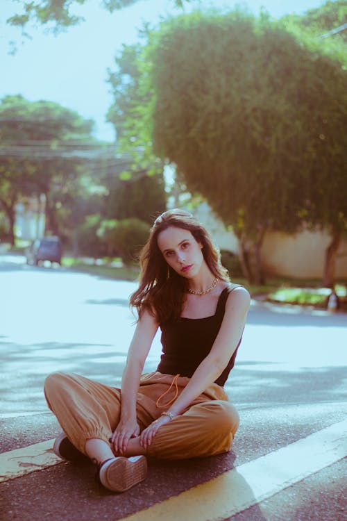 Beautiful Woman Sitting on City Street