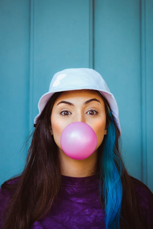Free Woman Blowing a Pink Bubble Gum  Stock Photo