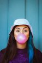 Woman Blowing a Pink Bubble Gum 
