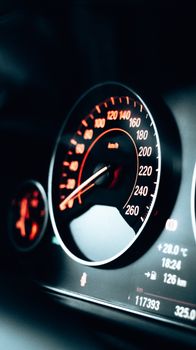Close-up view of a modern car speedometer with advanced technology and sleek design.