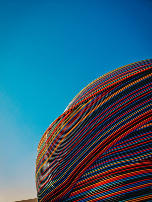 Free Vibrant striped architectural pavilion under a clear blue sky in Dubai. Modern design. Stock Photo
