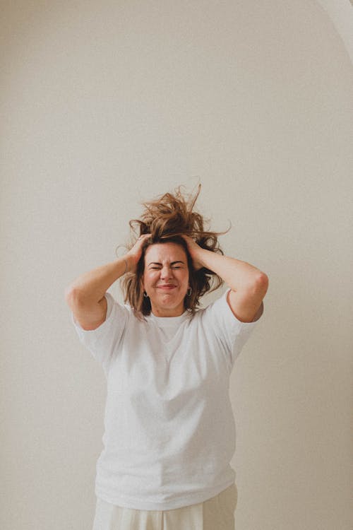 Woman with eyes Closed and Hands on Hair