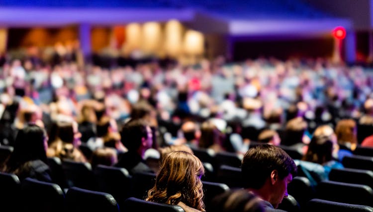 Audience Sitting In Chairs 