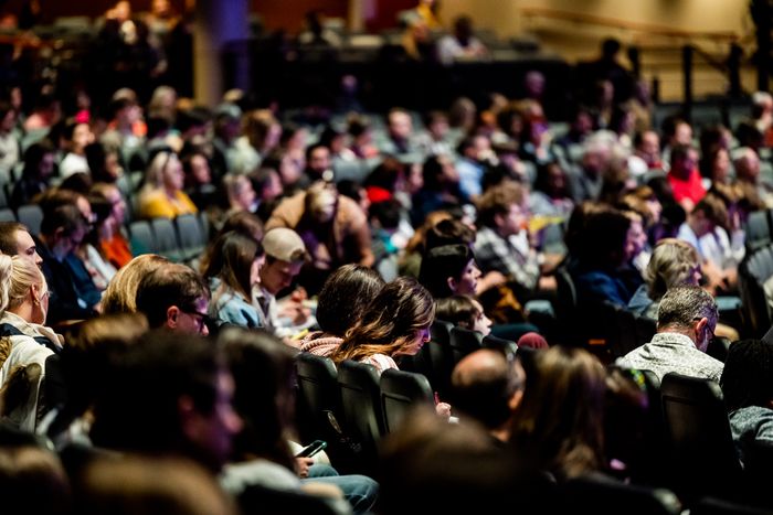 A crowd seated in an auditorium at a county town hall. Photo by Caleb Oquendo on Pexels