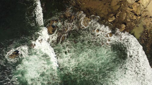 Aerial Photography of Waves Crashing on Rocky Shore