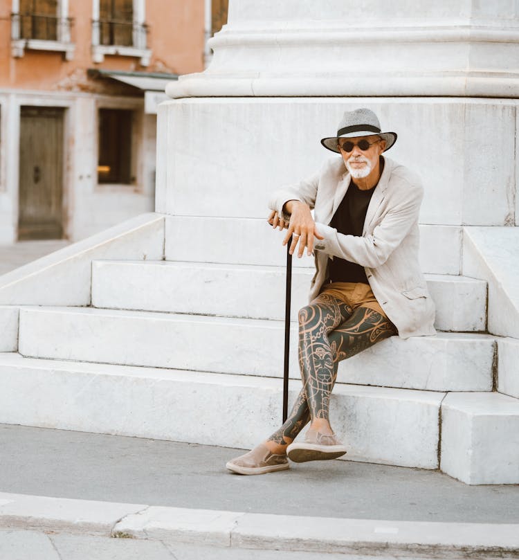 Man Sitting On White Stairs 