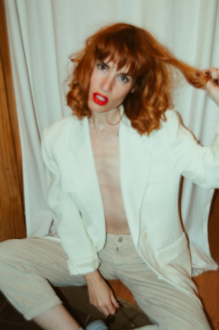 A Blur Photo Of Woman In White Blazer