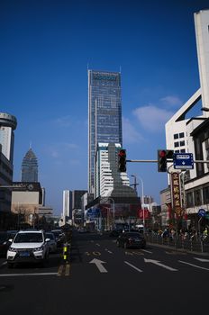 A bustling city street with towering skyscrapers and vibrant urban life.