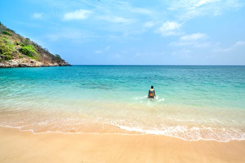 Person Bathing in Turquoise Water 