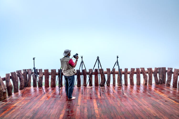 Man With Camera On Outdoor Terrace