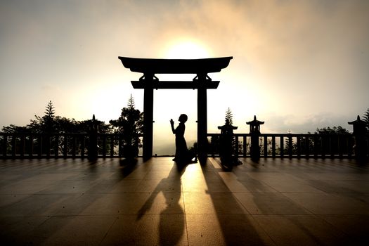Silhouette of a Person Praying During Sunset