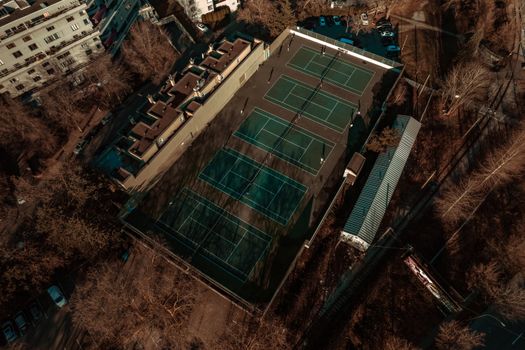 Aerial shot of multiple tennis courts surrounded by bare trees in Vancouver, BC.