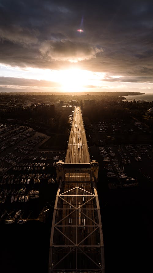 Free Drone view from above steel bridge during overcasted sunset Stock Photo