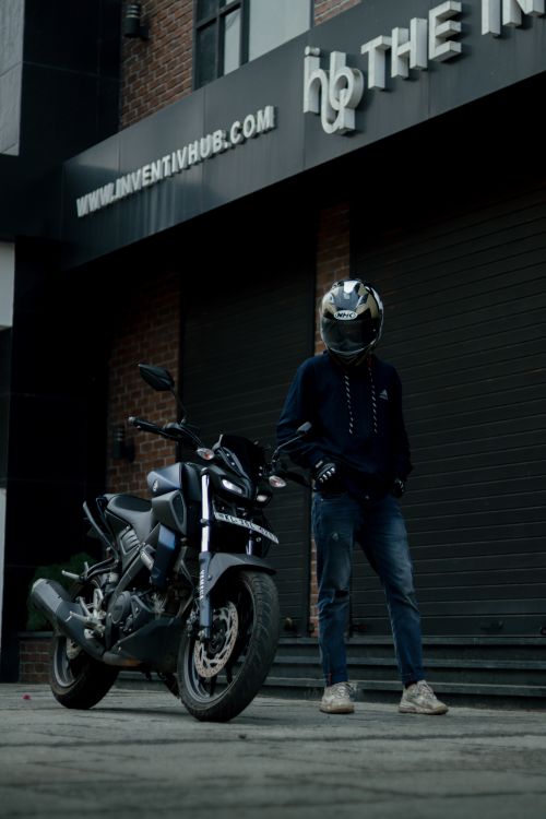 Cycle Rider Standing Rider standing beside a Sports Bike · Free Stock Photo
