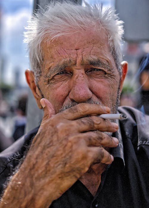 Free Close-up Photo of an Elderly Man smoking Cigarette  Stock Photo