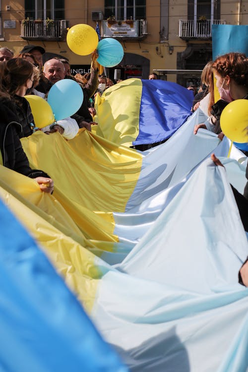 Free Group of People Holding Ukrainian Flag Stock Photo