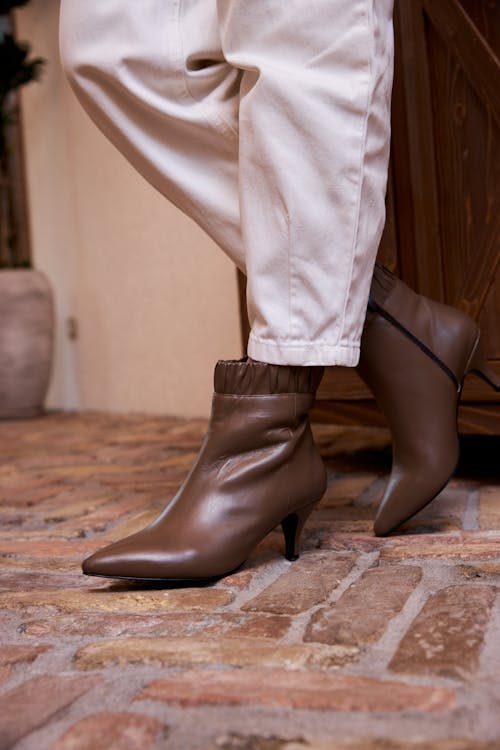 A Person Wearing Leather Heeled Shoes