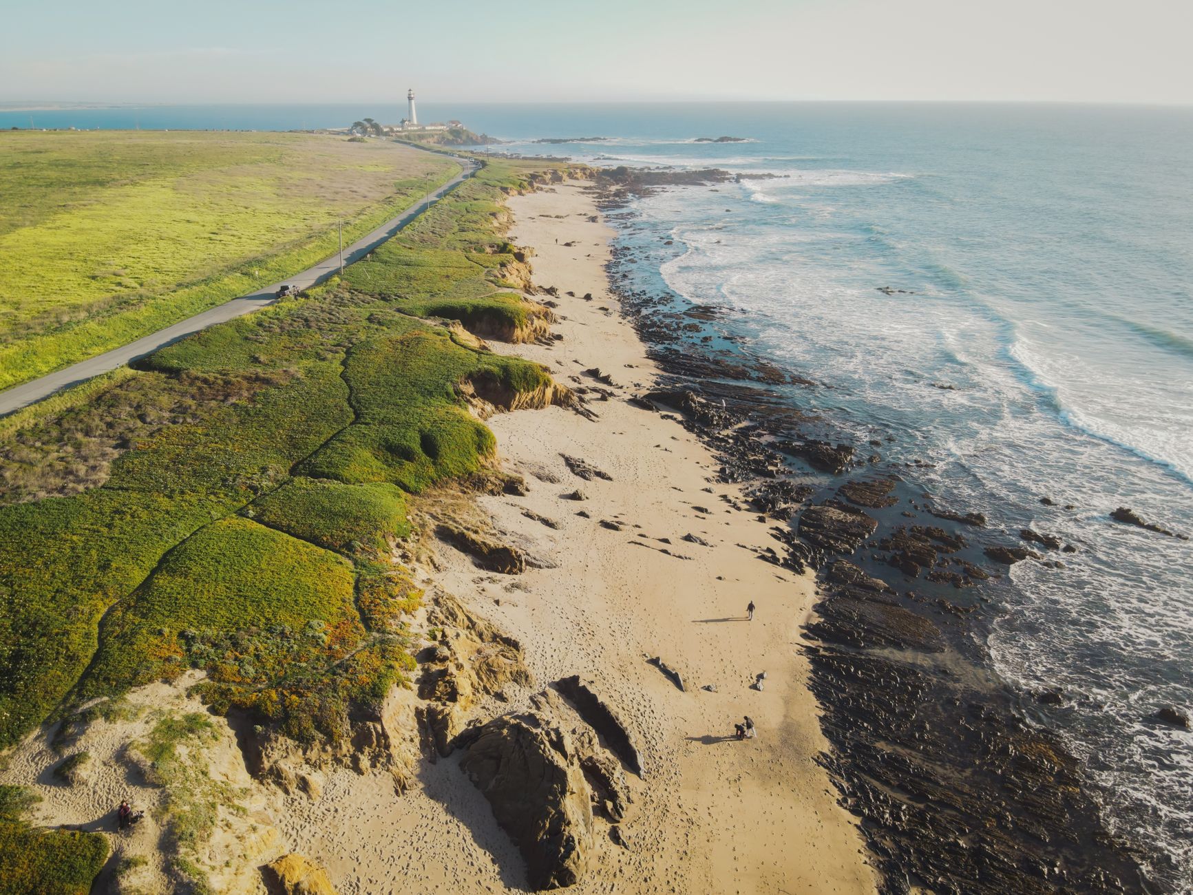A breathtaking aerial perspective of Pescadero Beach's scenic coastline and lighthouse.