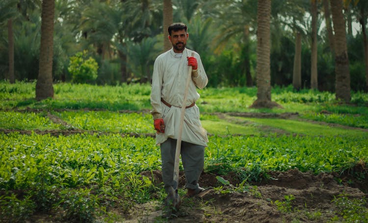 A Farmer Holding A Shovel