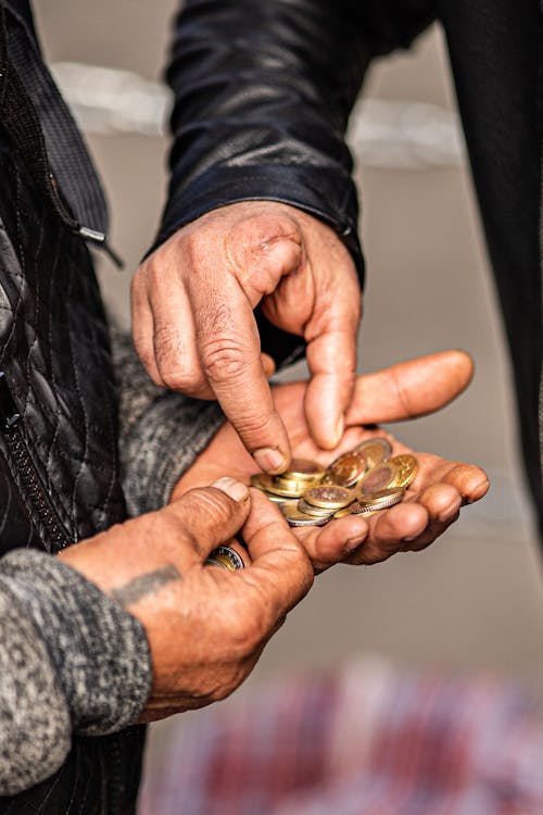 Person Holding Coins 