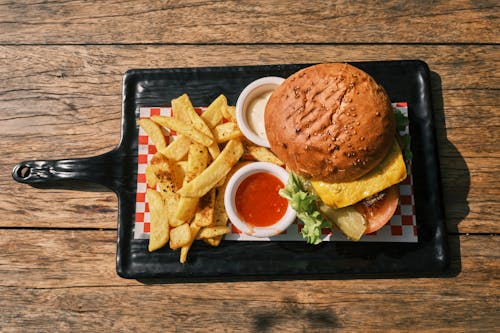 Free A Delicious Cheeseburger and French Fries on a Platter Stock Photo