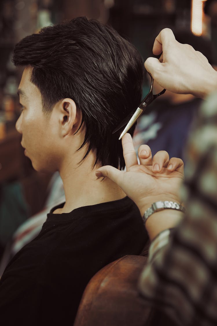 Unrecognizable Person Performing Careful Male Haircut