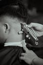 Unrecognizable Hands Trimming Male Haircut with Trimmer