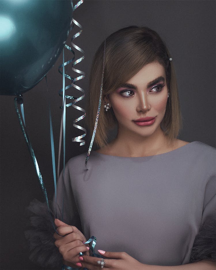 A Woman Holding A Balloon