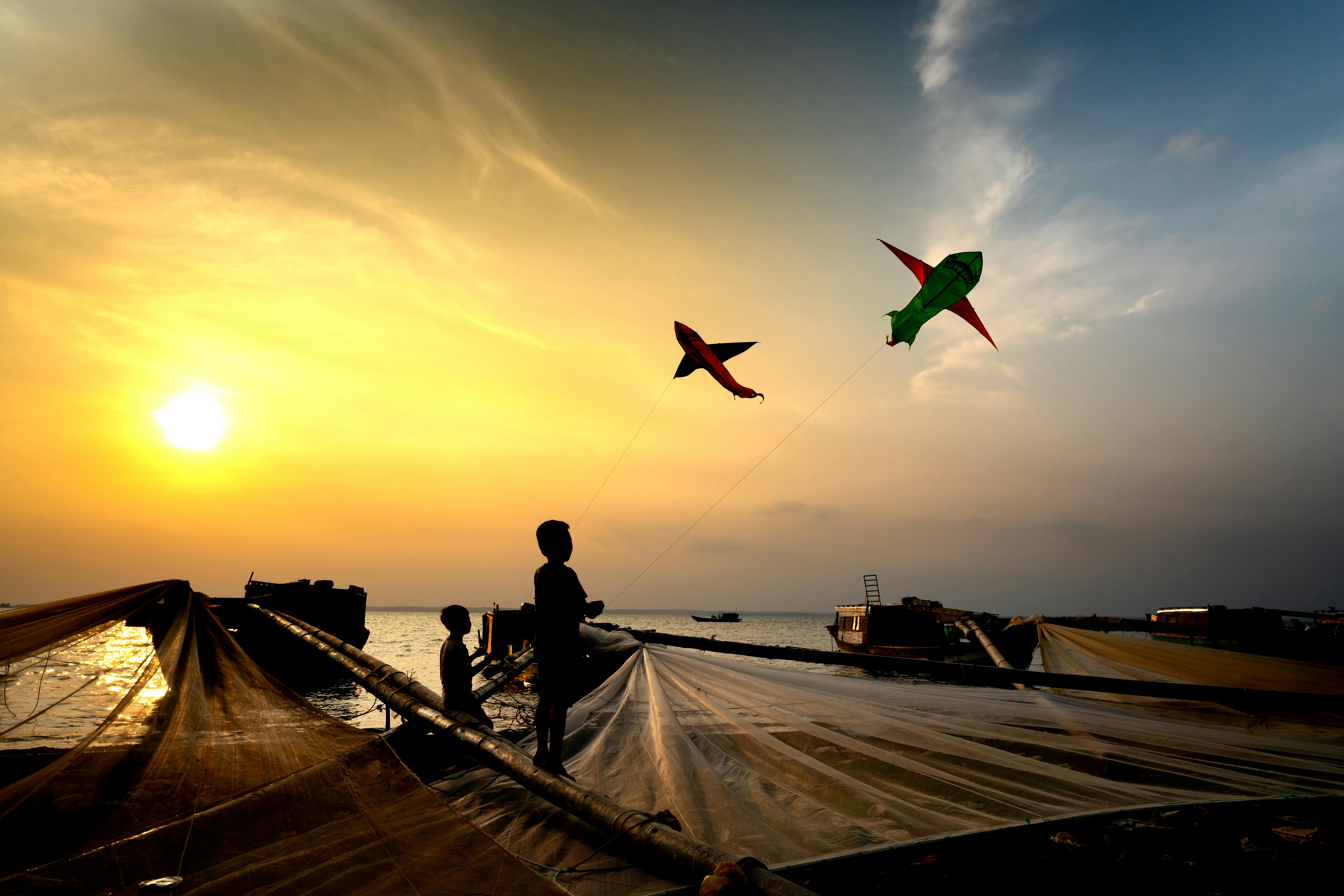 Boys Playing with Kites in Harbor · Free Stock Photo