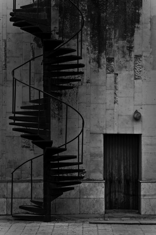 Black Spiral Staircase on Gray Concrete Wall