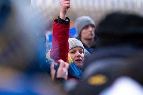 Free A Woman in Red Jacket Joining a Protest Stock Photo