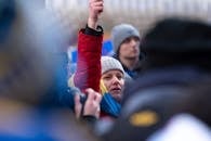 A Woman in Red Jacket Joining a Protest