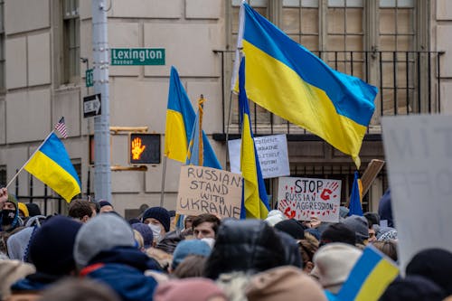 People Demonstrating on the Street with Flags and Posters