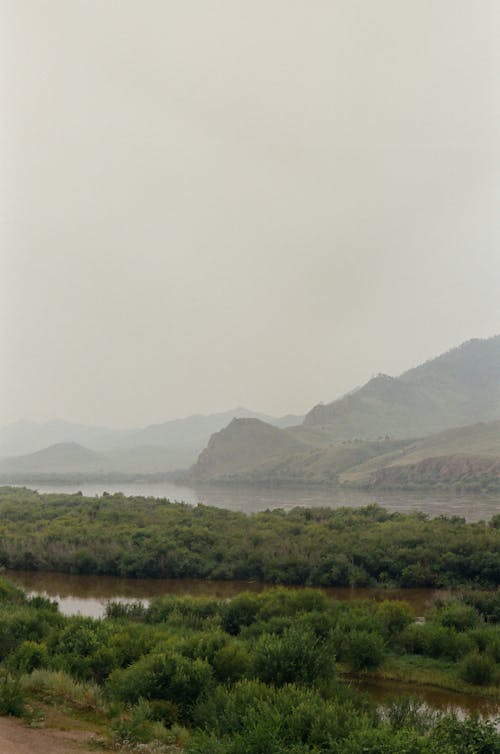  A River Near Mountain on a Foggy Day